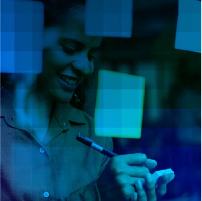 Marketing professional writing notes on sticky notes in office