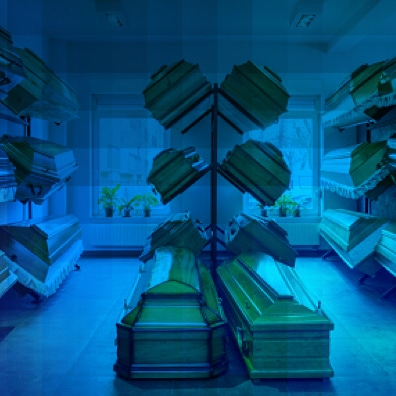 Casket showroom displaying multiple funeral caskets.