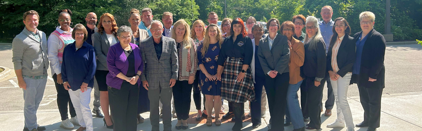 Posed group of professionals outside.
