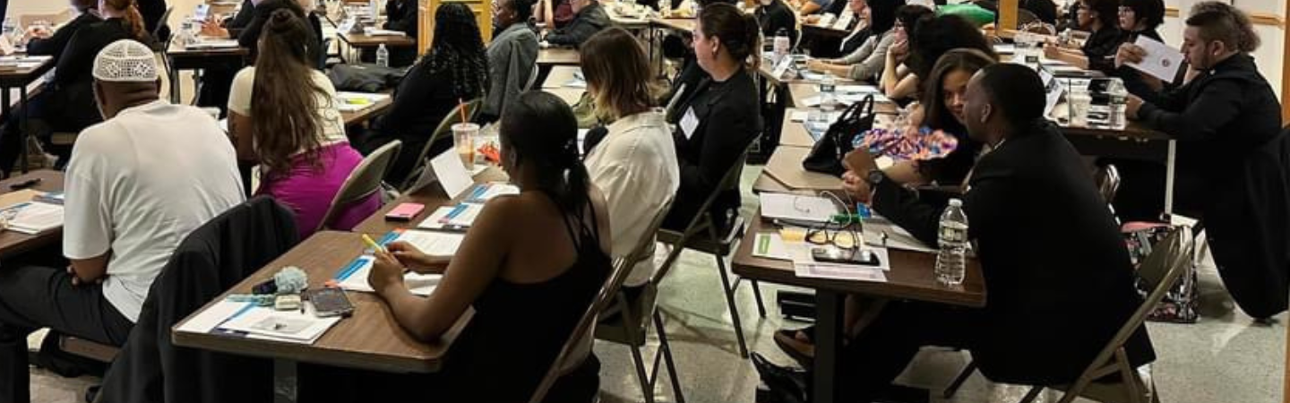 Training attendees sitting at tables.