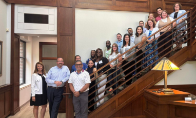 Group of people posing on a staircase.
