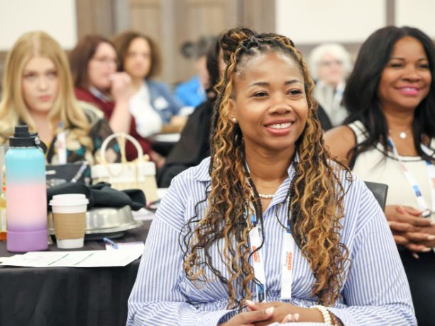 Female funeral directors smiling during a presentation